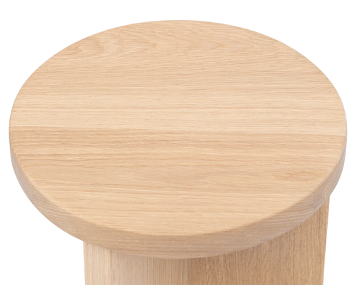 Top view of the Affe Pedestal by Crea, showcasing the smooth, rounded solid oak surface with visible wood grain texture.