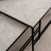 Detail view of the Anton Coffee Table by by Crea, showcasing Sabbia Dekton tops and black powder-coated steel frames. A modern nesting table set, handmade in Sweden with minimalist Scandinavian design and durable stone surfaces.