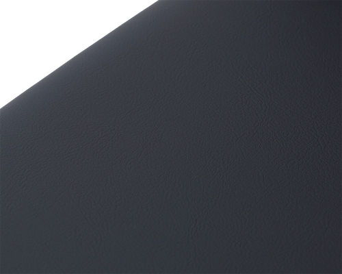 Macro detail of the Bella Dining Chair seat from by Crea, showcasing the fine-grain texture of the black vegan leather cushion in a soft matte finish.