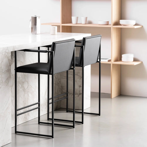 Bruno bar stools in jade black leather with matte black frame, designed for modern kitchen interiors.