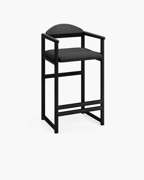 Carl bar stool in black oak with black bouclé seat, minimalist design perfect for everyday island seating.