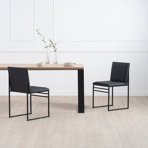 Diana dining table in black with oak featuring two stylish black chairs, perfect for a Scandinavian-inspired dining setup.