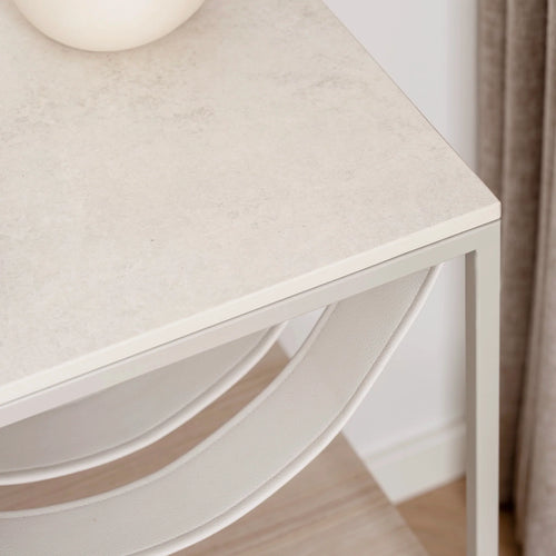 Close-up of the Iris bed table featuring a beige lunar dekton top and sleek frame, ideal for modern bedroom decor.