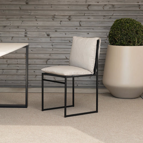 Isa outdoor chair in black frame with fossil acrylic, featuring minimalist Scandinavian design for timeless elegance.