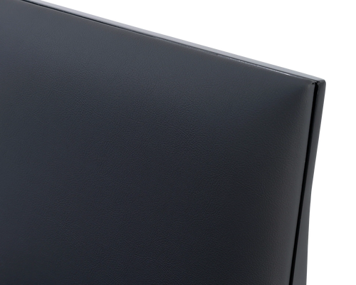 Close-up of the Isabell Dining Chair backrest by Crea, featuring smooth black vegan leather upholstery and a powder-coated steel frame for a refined Scandinavian look.