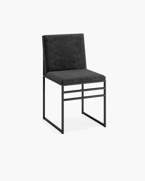 Elegant Isabell dining chair in black velvet with a sleek matching frame, perfect for modern dining spaces.