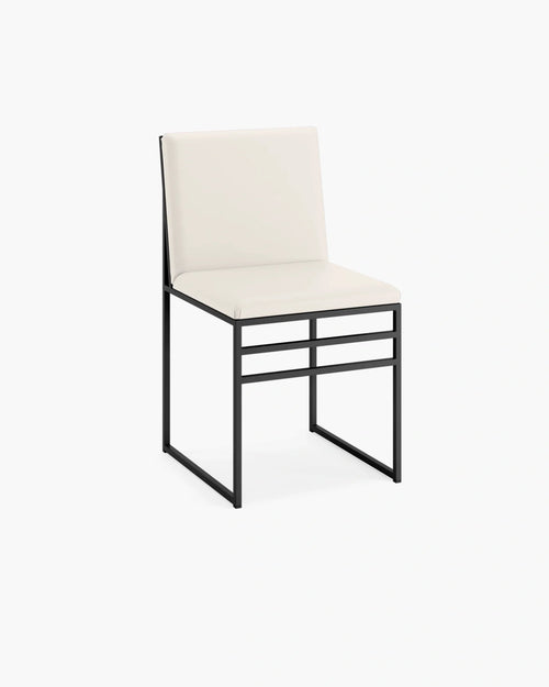 Isabell dining chair in sand leather with a sleek black frame, designed for a modern and inviting dining space.