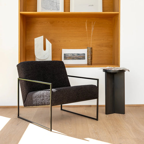 Kent Armchair in black bouclé, showcasing minimalist Scandinavian design in a contemporary living space.