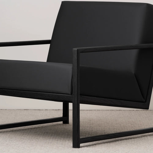 Kent Wood armchair in black oak with jade black leather seat, featuring stylish Scandinavian design and modern comfort.