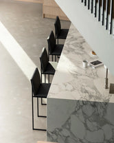 Set of four Philip bar stools in black frame and black vegan leather, styled at a modern marble kitchen island by by Crea.