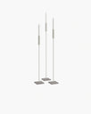 Set of beige floor candleholders with turbine grey bases, creating a serene and minimalist atmosphere.