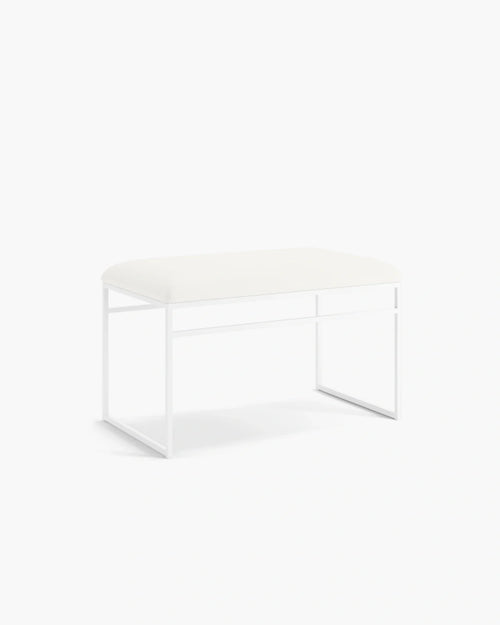 Wilma bench with white frame and cushion, featuring sleek Scandinavian design and minimalist aesthetic.