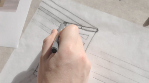 Designer sketching the Wilma wooden bench during the early design phase at by Crea, showcasing handcrafted Scandinavian furniture development.