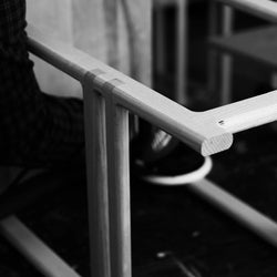 Close-up, black and white detail of a By Crea wooden furniture joint, showcasing precise craftsmanship and joinery techniques like finger joints, highlighting the quality and artisanal work. Perfect for furniture manufacturing, woodworking, and sustainable design.