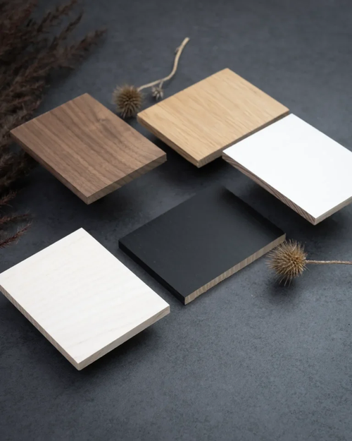 Five FSC-certified oak finish samples from by Crea displayed on a dark textured surface, featuring black, white, light oak, dark oak, and natural oak color options.