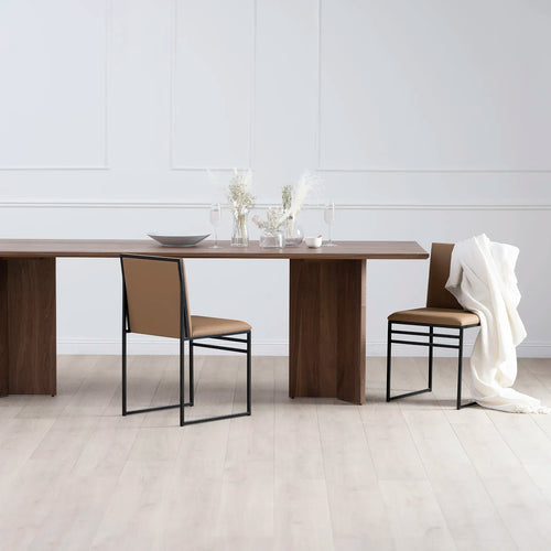 Ann dining table in dark oak with minimalist chairs, showcasing a sophisticated dining room setting.