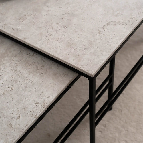 Detail view of the Anton Coffee Table by by Crea, showcasing Sabbia Dekton tops and black powder-coated steel frames. A modern nesting table set, handmade in Sweden with minimalist Scandinavian design and durable stone surfaces.