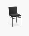 Bella dining chair in black bouclé with a soft cushion on a slim black frame, perfect for a minimalist decor.