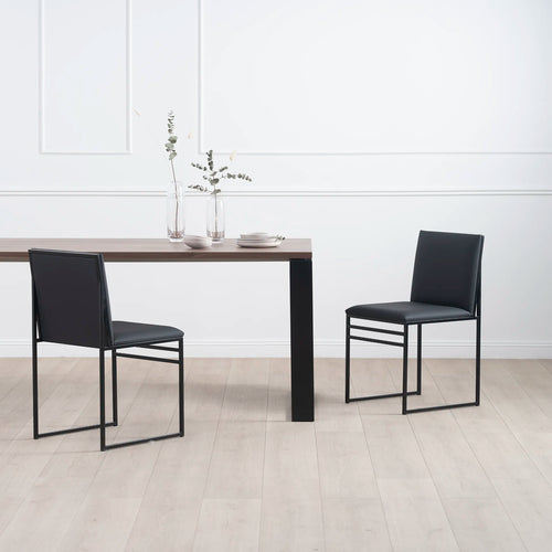 Diana dining table in black with dark oak, paired with modern black chairs, creating a minimalist dining space.