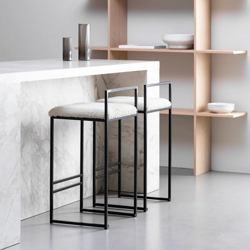 Freja bar stool featuring a black frame and ivory bouclé cushion, ideal for stylish home interiors.