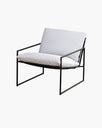 Kenny lounge chair in black frame with white cushions, combining modern design and comfort for any space.