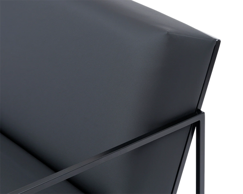 Close-up of Kent Steel Armchair backrest with sharp upholstery lines in black vegan leather, framed by sleek matte black steel | by Crea