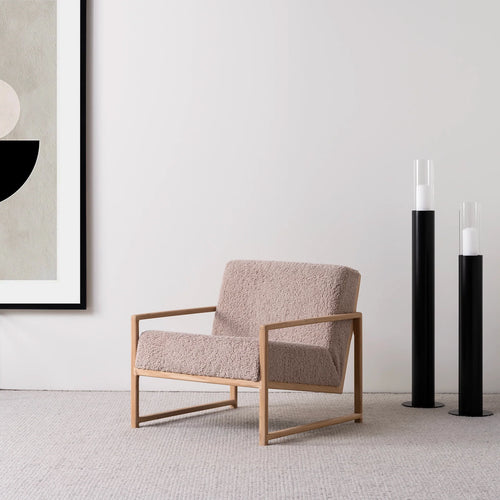 Scandinavian oak armchair with soft greige bouclé in modern living space, ideal for reading corners.