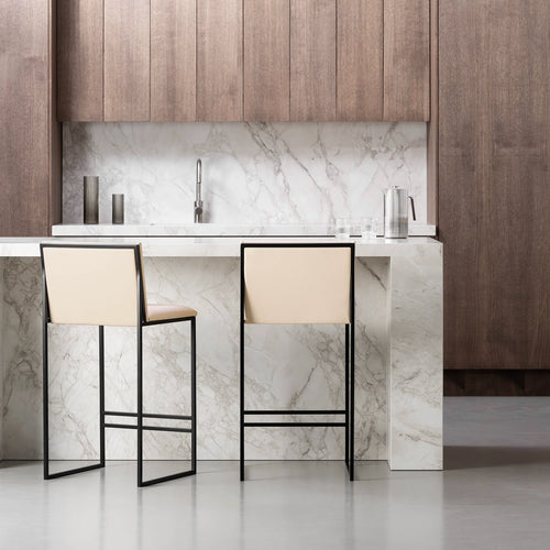 Philip bar stools in black frame and sand leather seat against a modern kitchen marble countertop.