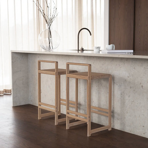 Ebba bar stools in oak at a modern kitchen counter with minimalist design and natural wood finish.