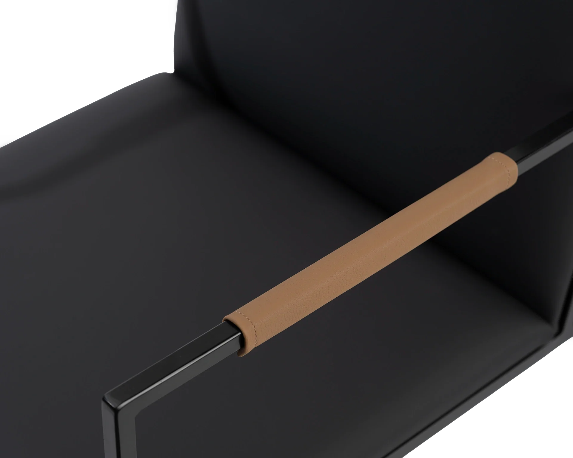 Close-up of Sella Dining Chair’s tan vegan leather-wrapped armrest by Crea, set against black frame and seat, showcasing detail and Scandinavian elegance.