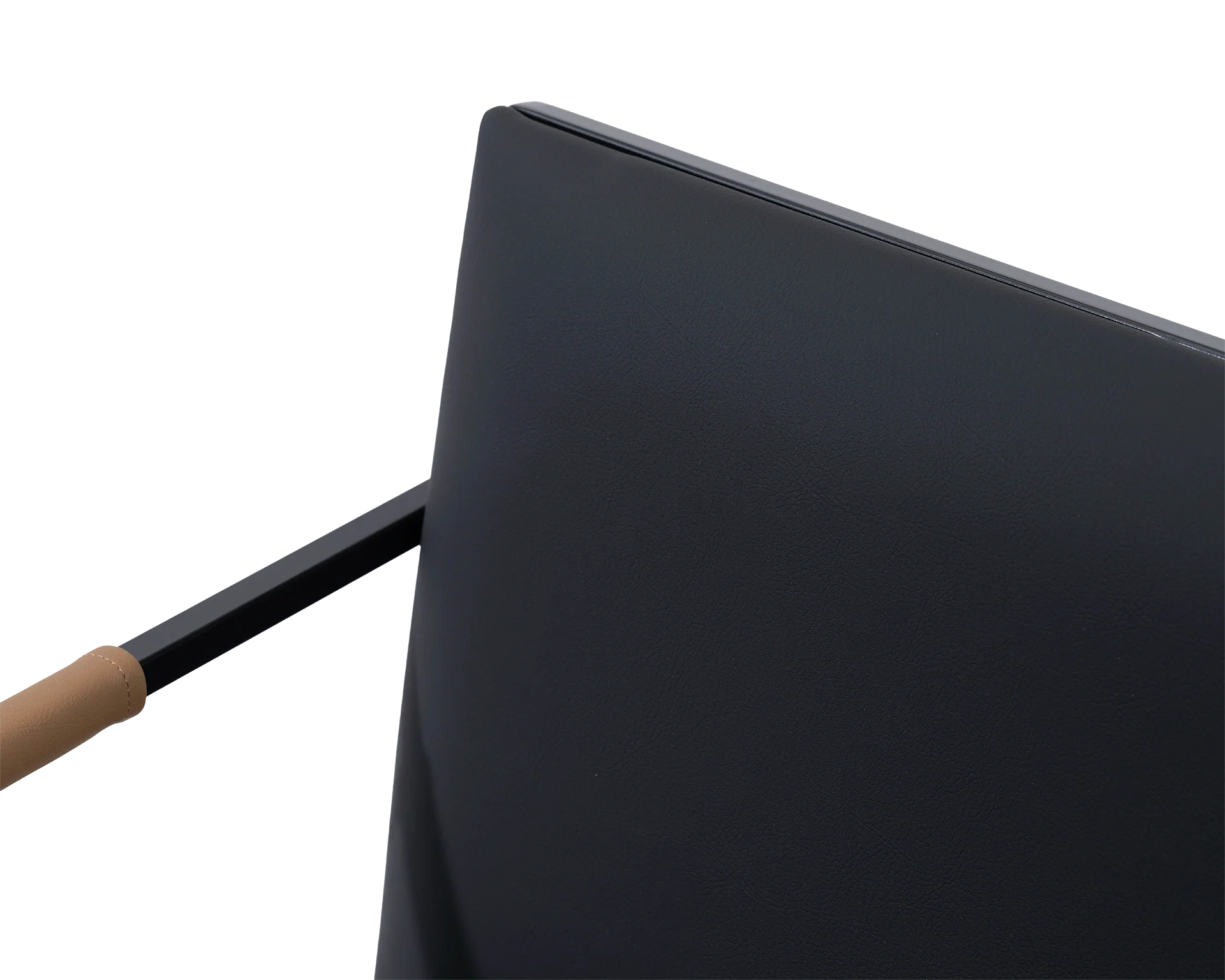 Detail of the Sella Chair backrest in smooth vegan leather with black steel frame and tan armrest accent, minimalistic Scandinavian design.