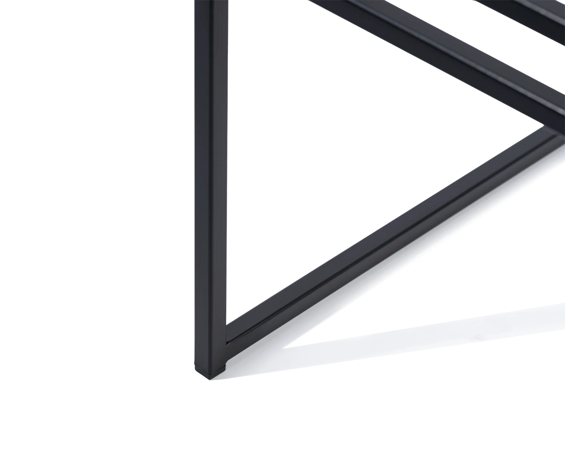 Close-up of the Sella Dining Chair by Crea showing the black powder-coated steel foot with protective plastic glider, highlighting floor-safe minimalist design and Scandinavian craftsmanship.