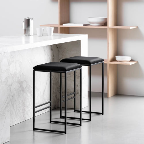 Svea bar stools in black velvet with a sleek black frame, perfect for modern kitchens and high tables.