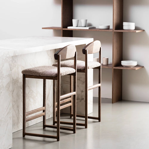 Dark oak Ted bar stool with greige bouclé seat, perfect for stylish elevated dining spaces.