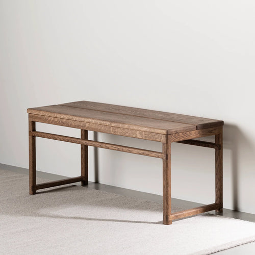 Wilma wood bench in dark oak finish, adding warmth and style to any home interior.
